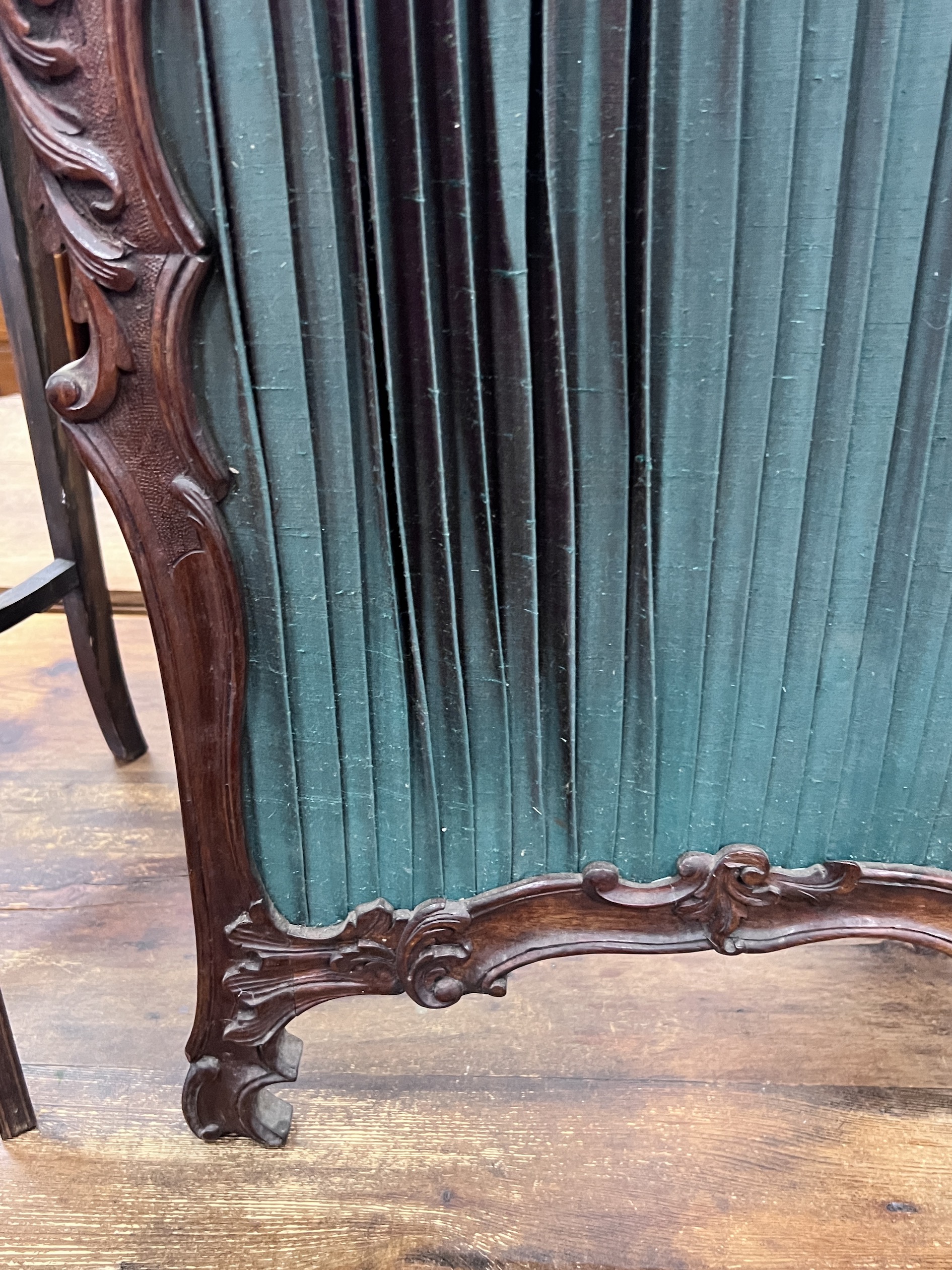 A small Victorian style mahogany two fold carved screen, each panel width 50cm, height 112cm